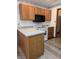 A functional kitchen featuring wood cabinets, laminate countertops, and modern appliances at 1311 Aaron Dr, Shelbyville, IN 46176