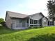 Back exterior featuring a deck and a sunroom addition with large windows at 1311 Aaron Dr, Shelbyville, IN 46176
