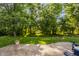 Lush backyard with a stamped concrete patio, inviting fire pit, mature trees, and landscaped area at 1343 Turfway Dr, Avon, IN 46123