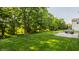 Lush green backyard featuring a stamped concrete patio and mature trees at 1343 Turfway Dr, Avon, IN 46123
