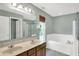 Bathroom featuring a double vanity, a large tub, and a shower at 1343 Turfway Dr, Avon, IN 46123