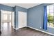 Cozy bedroom with blue accent wall, closet, and large window at 1343 Turfway Dr, Avon, IN 46123