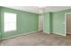 Bedroom with green walls, a window with blinds, tan carpet and a modern ceiling light fixture at 1343 Turfway Dr, Avon, IN 46123