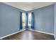 Comfortable bedroom featuring blue walls, natural light, and wood floors at 1343 Turfway Dr, Avon, IN 46123