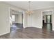 Spacious dining area showcasing an elegant chandelier, dark wood floors, and great natural lighting at 1343 Turfway Dr, Avon, IN 46123