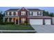 Charming two-story home with a well-manicured lawn, brick facade, and a spacious two car garage at 1343 Turfway Dr, Avon, IN 46123