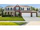 Charming two-story home with a well-manicured lawn and a two car attached garage at 1343 Turfway Dr, Avon, IN 46123