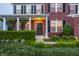 Beautiful brick home with a manicured lawn, colorful flower beds, and a welcoming front porch at 1343 Turfway Dr, Avon, IN 46123