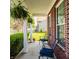 Cozy front porch with outdoor seating, hanging plants, and a brick exterior at 1343 Turfway Dr, Avon, IN 46123