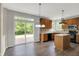 Eat-in kitchen with wooden cabinets, granite countertops, island and sliding glass doors at 1343 Turfway Dr, Avon, IN 46123