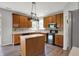 Kitchen featuring wood cabinets, black appliances, island and tile backsplash at 1343 Turfway Dr, Avon, IN 46123