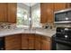 Kitchen featuring wood cabinets, stainless steel microwave, and tile backsplash at 1343 Turfway Dr, Avon, IN 46123