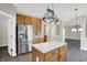Modern kitchen featuring stainless steel appliances, granite countertops, and a stylish island with wooden cabinets at 1343 Turfway Dr, Avon, IN 46123