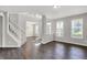 Bright living room featuring hardwood floors, neutral paint, and staircase access at 1343 Turfway Dr, Avon, IN 46123