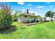 Spacious backyard featuring lush green grass and a well-maintained exterior, with a detached garage at 1411 N Kenmore Rd, Indianapolis, IN 46219