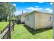 Yard featuring a shed, a house and green grass at 1411 N Kenmore Rd, Indianapolis, IN 46219