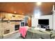 Cozy basement featuring a fireplace, wood paneling, and a comfortable seating area, perfect for relaxation at 1411 N Kenmore Rd, Indianapolis, IN 46219