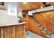 Basement featuring a wooden bar, stairs, and unique decorative elements, ready for entertainment at 1411 N Kenmore Rd, Indianapolis, IN 46219