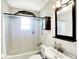 Bright bathroom featuring a vanity, mirror, shower, and a decorative touch above the shower curtain rod at 1411 N Kenmore Rd, Indianapolis, IN 46219