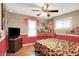 Bright bedroom with hardwood floors, a ceiling fan, and unique artistic elements at 1411 N Kenmore Rd, Indianapolis, IN 46219