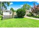 Exterior of the property showing the house, shed, and manicured lawn at 1411 N Kenmore Rd, Indianapolis, IN 46219