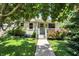 Charming single-story home with a cozy front porch, lovely landscaping, and a well-maintained lawn at 1411 N Kenmore Rd, Indianapolis, IN 46219