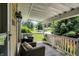 Charming front porch with chairs, a great view, and classic architectural details at 1411 N Kenmore Rd, Indianapolis, IN 46219
