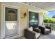 Welcoming front porch with chairs, a porch view, and a view of the house number at 1411 N Kenmore Rd, Indianapolis, IN 46219