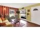 Eclectic living room with hardwood floors, a window-filled view and comfortable seating at 1411 N Kenmore Rd, Indianapolis, IN 46219