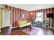 Inviting living room with wood floors, cozy furnishings, and a striped accent wall at 1411 N Kenmore Rd, Indianapolis, IN 46219