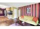 Spacious living room showcasing hardwood floors, colorful walls, and an open layout at 1411 N Kenmore Rd, Indianapolis, IN 46219