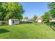 A well-manicured backyard features a storage shed and lush green lawn, perfect for outdoor activities at 1450 Millridge Dr, Greenwood, IN 46143