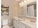 Bright bathroom features double sinks, two large mirrors, and plenty of storage at 1450 Millridge Dr, Greenwood, IN 46143