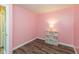 Vibrant bedroom with pink walls, wood floors, and a decorative shelf with storage at 1450 Millridge Dr, Greenwood, IN 46143