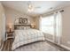 Cozy bedroom with a ceiling fan, comfortable bed, and warm, neutral wall color at 1450 Millridge Dr, Greenwood, IN 46143