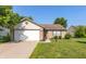 Charming single-story home featuring a well-manicured lawn, brick accents, and an attached two-car garage at 1450 Millridge Dr, Greenwood, IN 46143