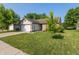 Well-maintained single-story home with an attached two-car garage, green lawn, and lovely landscaping at 1450 Millridge Dr, Greenwood, IN 46143