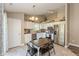 Bright kitchen featuring white cabinets, stainless steel appliances, and a dining table with seating for four at 1450 Millridge Dr, Greenwood, IN 46143