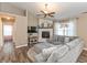 Cozy living room with a fireplace, ceiling fan, wood-look floors, and a comfortable gray sectional sofa at 1450 Millridge Dr, Greenwood, IN 46143