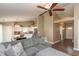 Spacious living room that opens to the kitchen, featuring a comfortable gray sectional sofa and ceiling fan at 1450 Millridge Dr, Greenwood, IN 46143