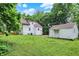 Well-maintained backyard with lush greenery, detached garage, and charming details at 1511 E Edwards Ave, Indianapolis, IN 46227