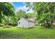 Lush backyard showcasing green lawn, partial fencing, and a detached garage at 1511 E Edwards Ave, Indianapolis, IN 46227