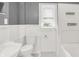 Clean white bathroom features wainscoting, a toilet, and a bathtub with shower at 1511 E Edwards Ave, Indianapolis, IN 46227