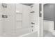 Bright white bathroom with shower and tub combo is updated and functional at 1511 E Edwards Ave, Indianapolis, IN 46227