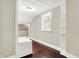 Bedroom with hardwood floors, a built-in bench, closet space, and natural light at 1511 E Edwards Ave, Indianapolis, IN 46227