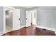 Bedroom featuring hardwood floors, fresh paint, and convenient access to adjacent rooms and closet at 1511 E Edwards Ave, Indianapolis, IN 46227