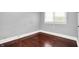 Bedroom showcasing hardwood floors, neutral paint, and natural light through the window at 1511 E Edwards Ave, Indianapolis, IN 46227