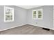 Neutral-toned bedroom with soft carpeting, bright windows, and minimalist decor at 1511 E Edwards Ave, Indianapolis, IN 46227