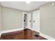 Neutral bedroom features hardwood floors and white trim for a bright and airy feel at 1511 E Edwards Ave, Indianapolis, IN 46227