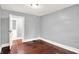 A bright bedroom with hardwood floors, light gray walls, and classic trim, offering a cozy space at 1511 E Edwards Ave, Indianapolis, IN 46227